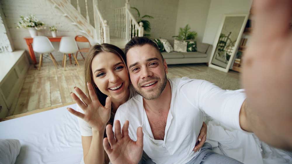 couple waving on video chat