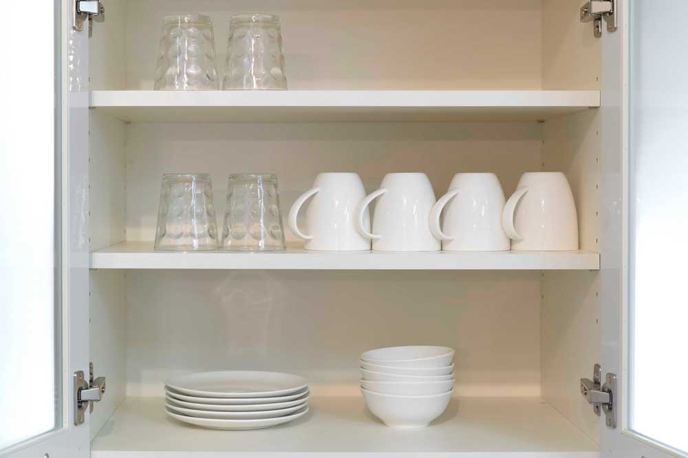 cabinet with organized coffee cups and glasses