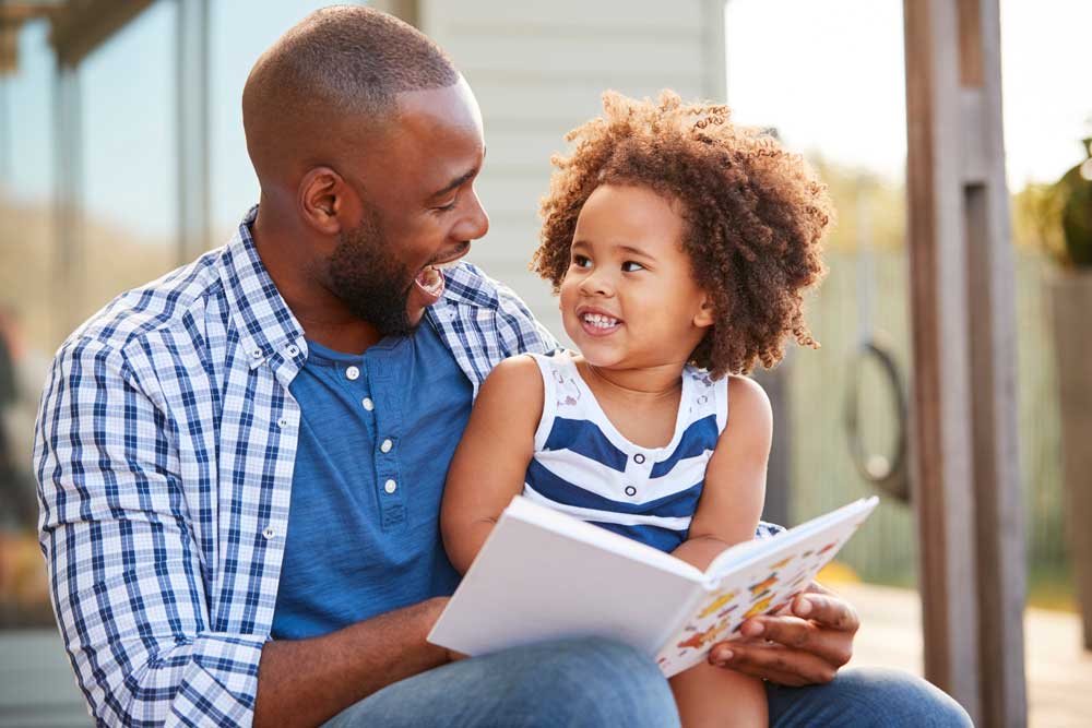 father reading to his daughter during the quarantine