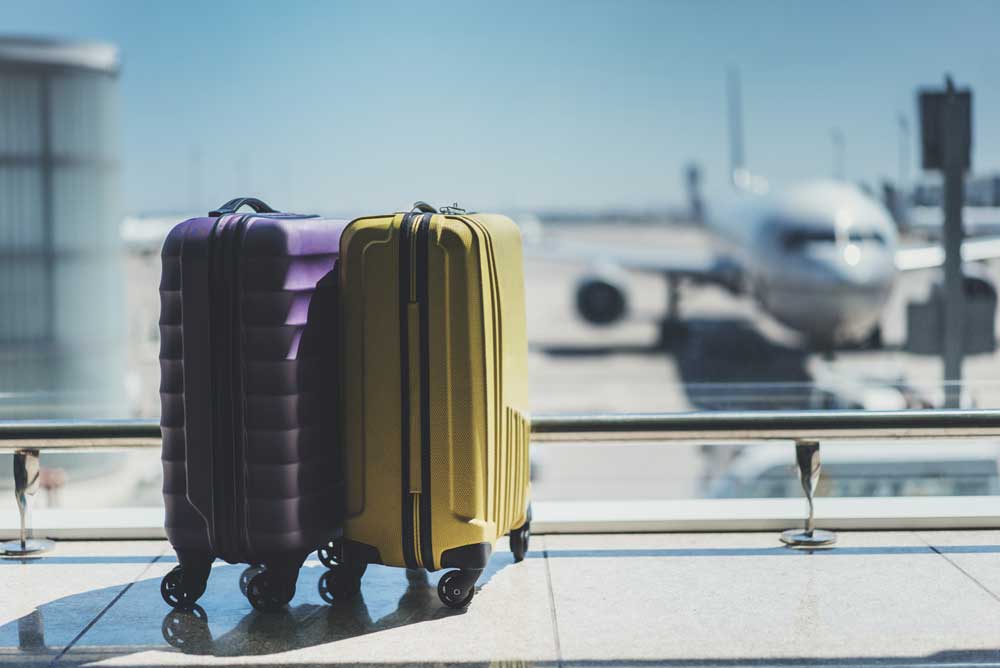 suitcases sit in front of departure gate.